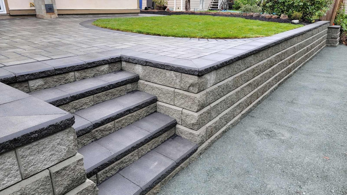 24_Elegant paver patio with lush green lawn and tiered landscaping by Back40 Landscaping in Abbotsford, BC