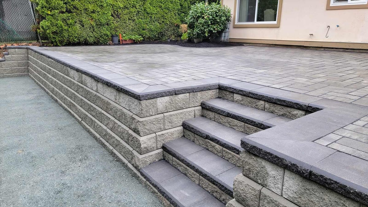 25_Completed patio and garden area with detailed paver design and fresh landscaping by Back40 Landscaping in Abbotsford, BC