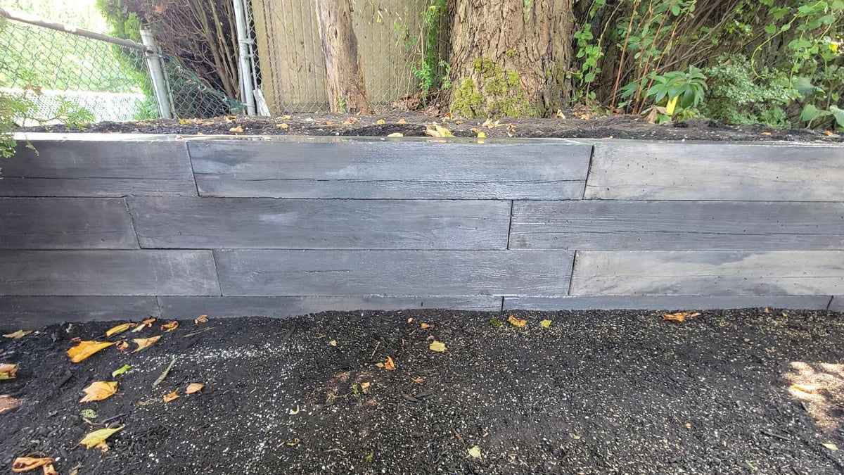 Close-up of concrete pavers with polished finish in backyard patio by Back 40 Landscaping, Abbotsford, BC