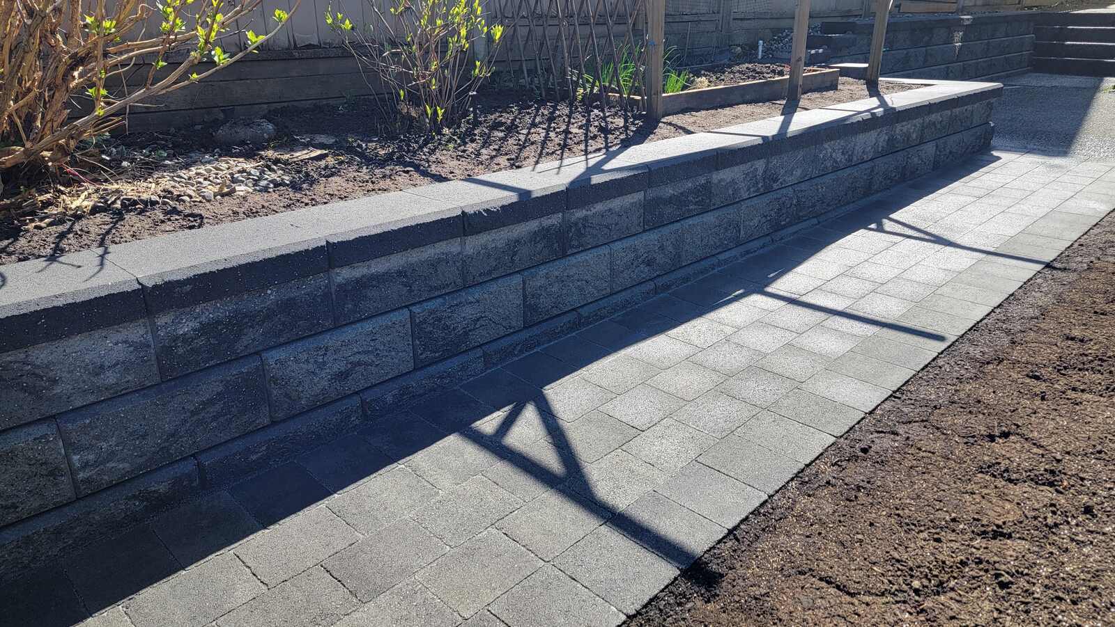 17_modern-stone-retaining-wall-with-clean-paved-path-built-by-back40-landscaping-in-burnaby-bc