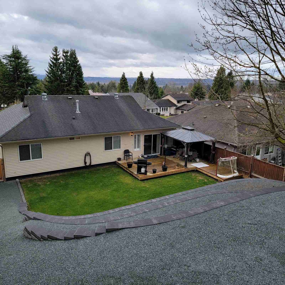 View from above showing backyard with lawn and retaining wall in Langley, BC by Back 40 Landscaping