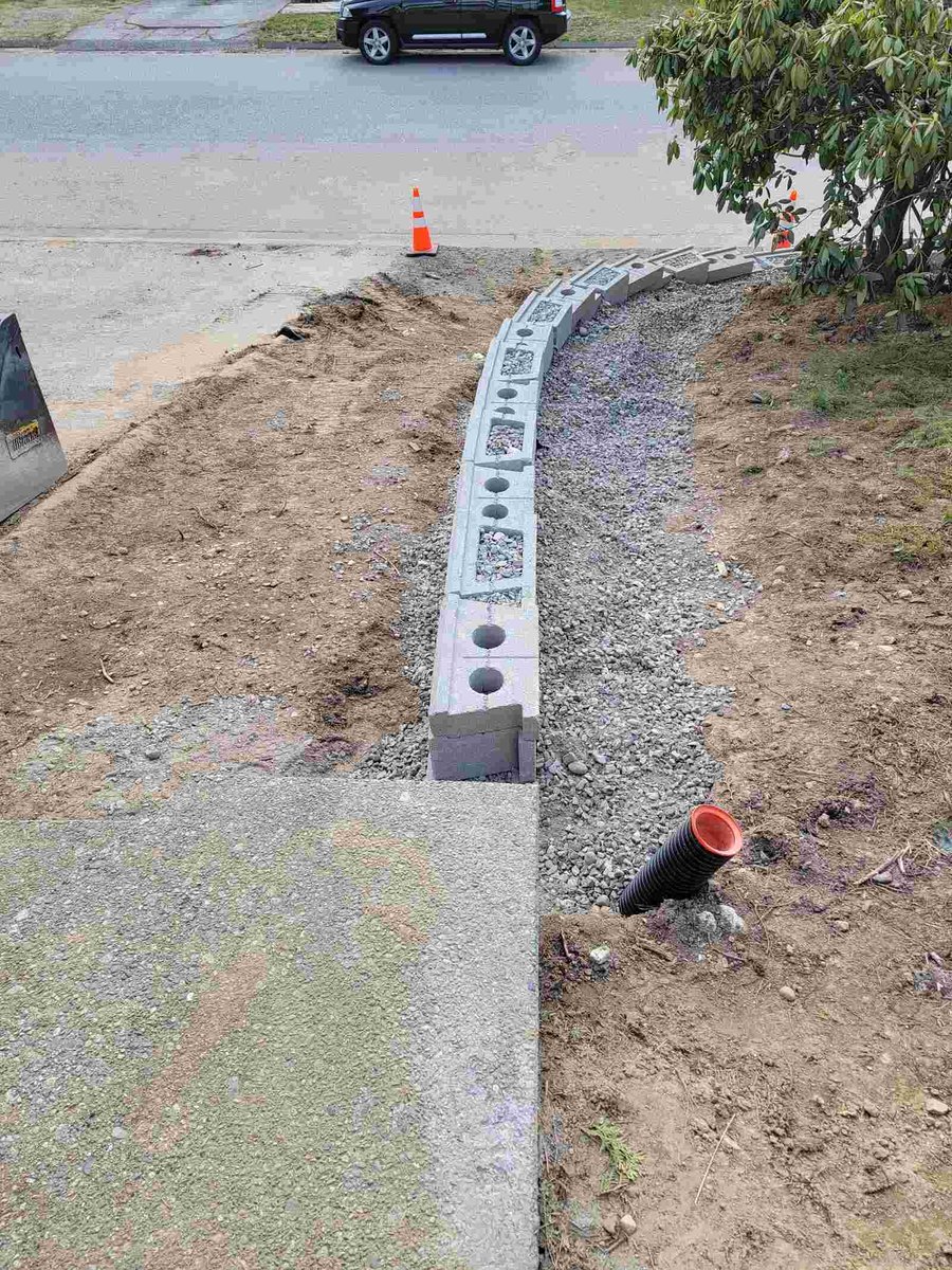 Back 40 Landscaping builds a retaining wall foundation in Mission, BC, as part of a landscaping project