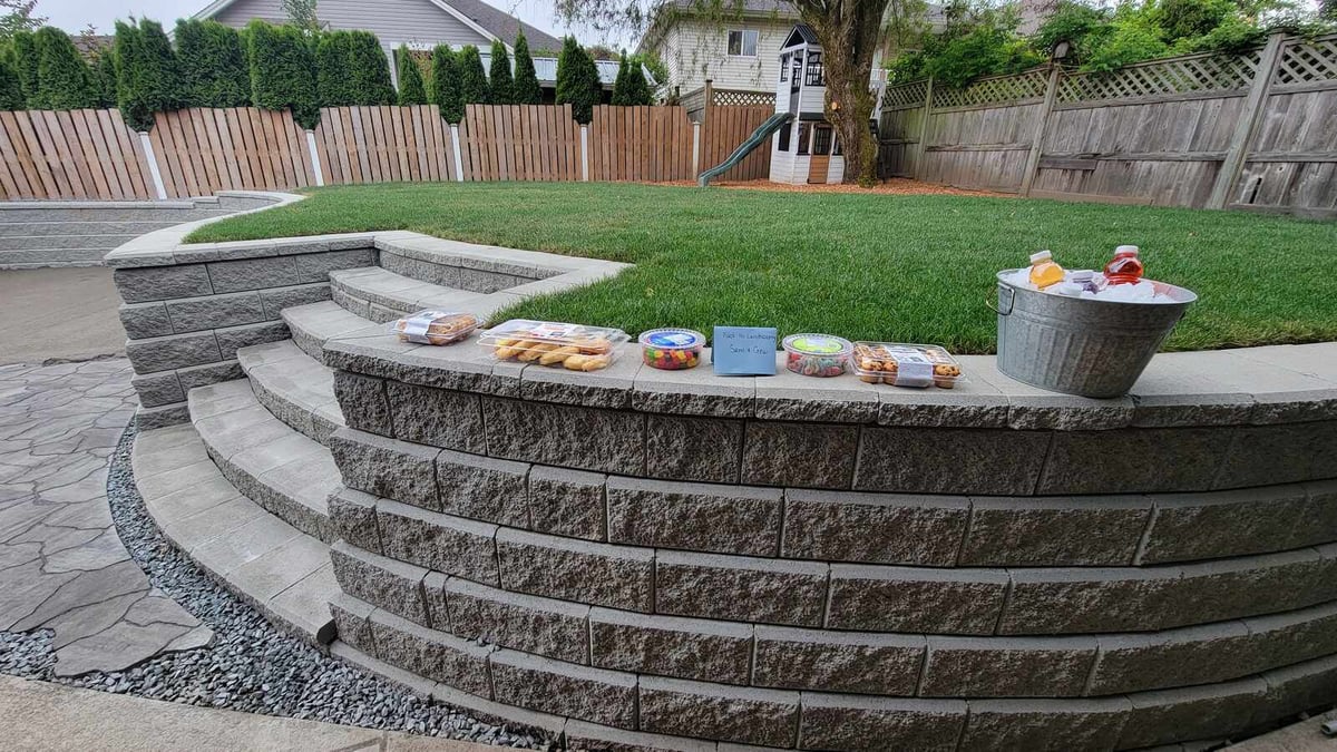 Outdoor steps and retaining wall by Back 40 Landscaping with refreshments laid out in Mission, BC