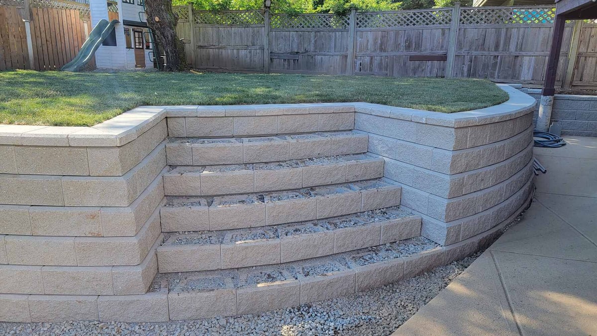 14_Backyard patio with flagstone design and curved retaining wall by Back40 Landscaping in Mission, BC